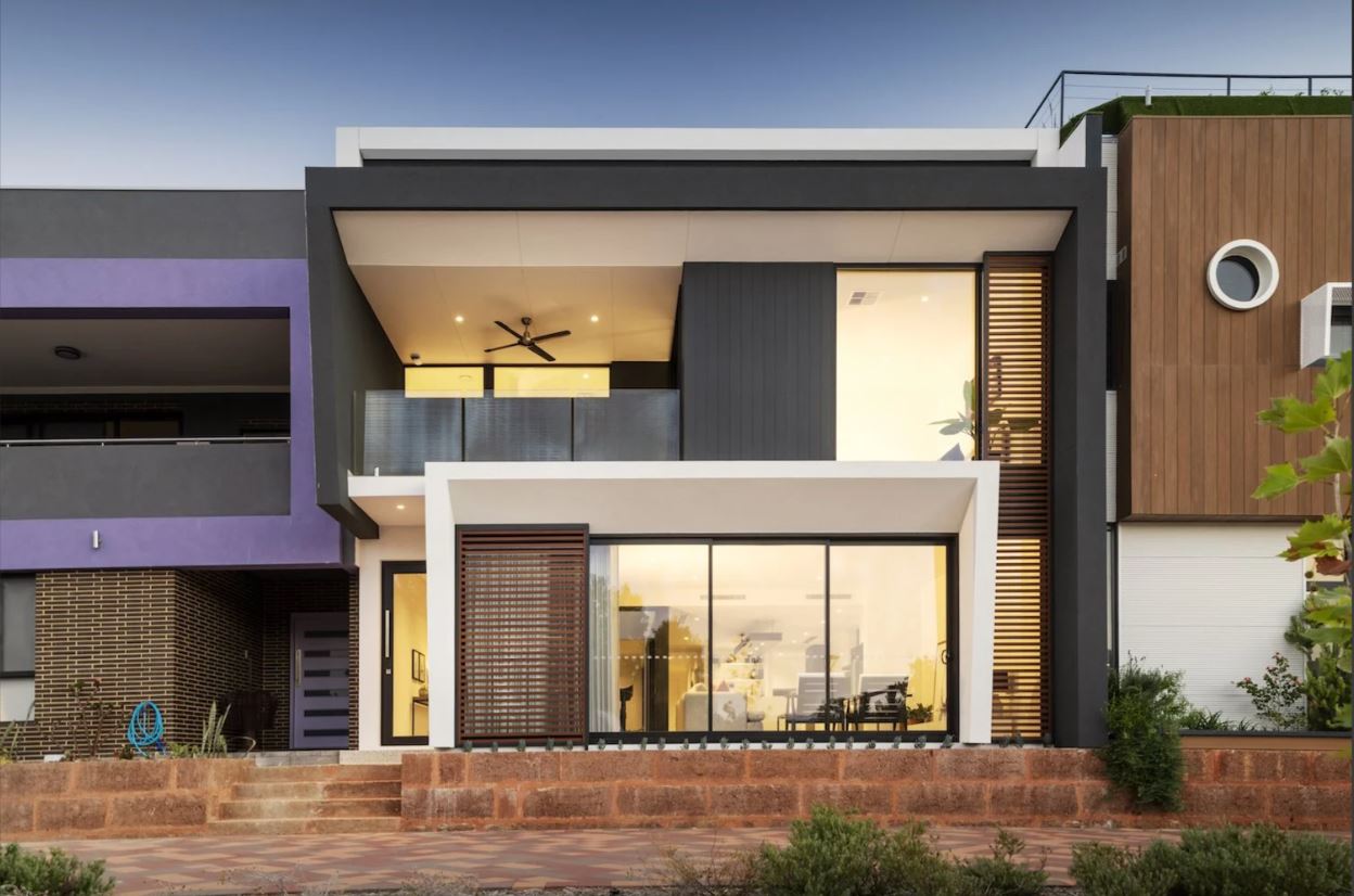 A grey and white modern two-story house design by Perth building company Residential Attitudes with a thin window running from top to bottom on the right.